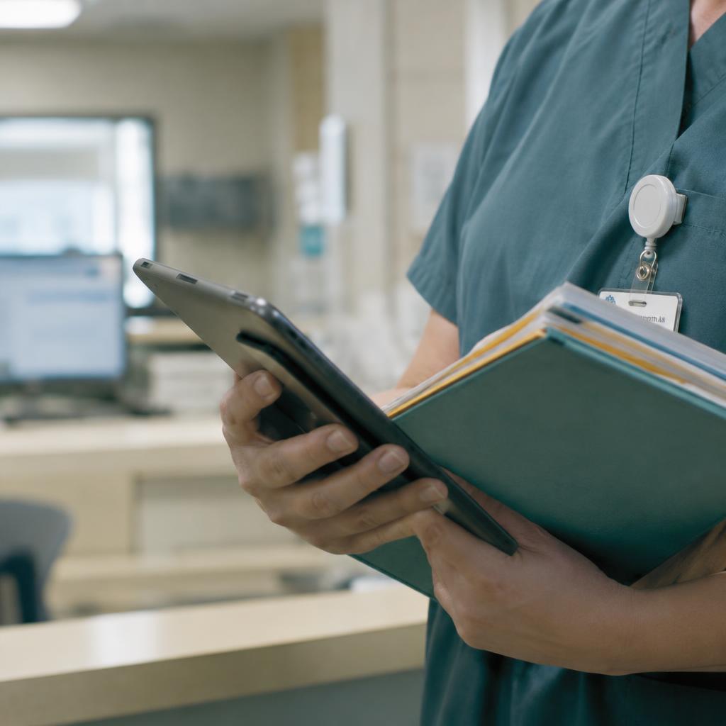 Nurse holding a tablet and documents